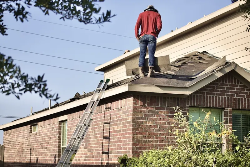 Professional roofer working on a residential roof in West Lake Hills